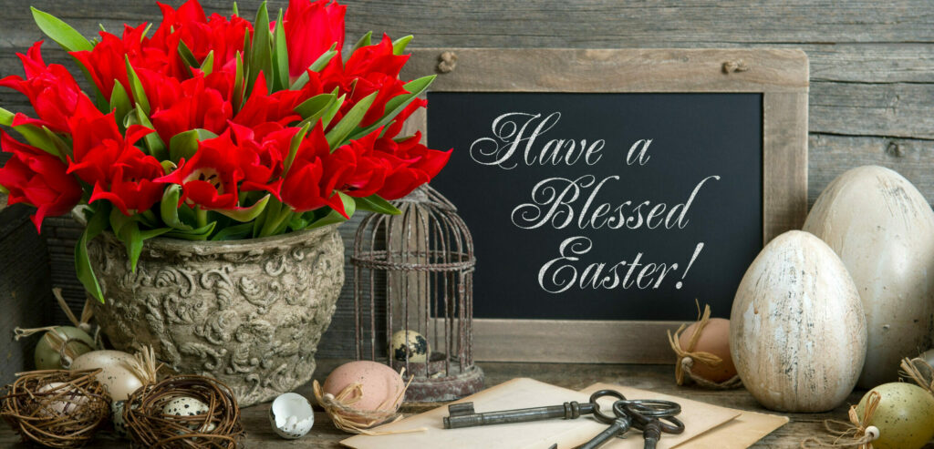 vintage easter decoration with eggs and red tulip flowers. nostalgic festive background with sample text Have a Blessed Easter!